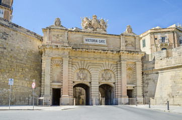 Fototapeta na wymiar Victoria Gate with the walls of St. Barbara Bastion