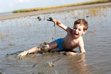 Boy lying in healing mud