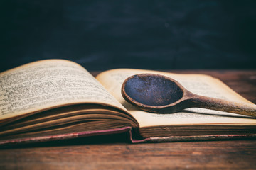 Wooden spoon on a vintage book