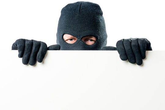 Portrait of the criminal in the mask with a large poster for the inscription