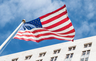 Pride of America. American flag on the background of the City Hall of Los Angeles