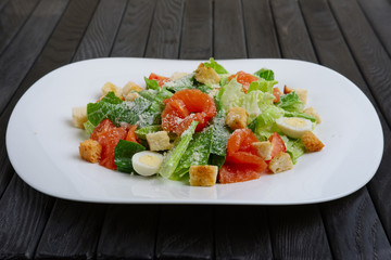 salad with quail egg, salmon fillet and vegetables with cheese