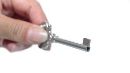 Hand holding key to success over white