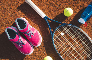 Tennis equipment laying on the court
