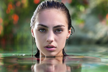 beautiful young woman relaxing in the spa pool