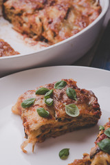 Delicious lasagna in white plates