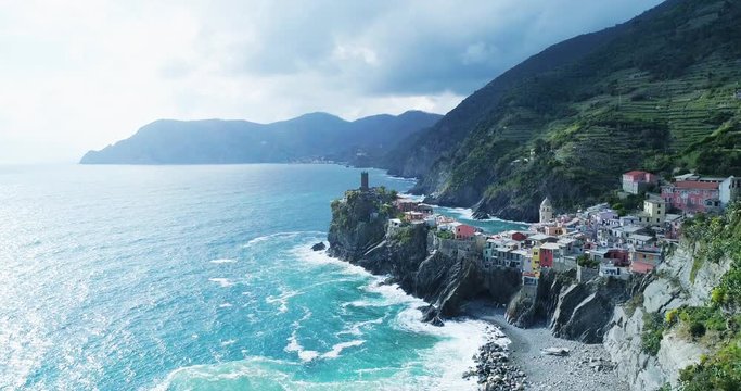 aerial view of travel landmark destination Vernazza,small mediterranean sea town,Cinque terre National Park, Liguria, Italy.Afternoon sunny and cloud weather.4k slow motion 60 fps drone side video