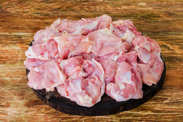 Fresh raw chicken meat ,chopped and prepared for cooking on wooden background. Close-up.