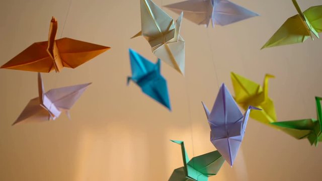 Dreamy origami crane birds background, colorful handmade paper toys, art
