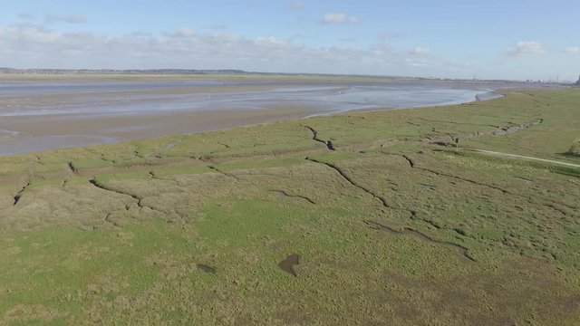 Aerial footage flying close to Flint Castle turret with view of Dee Estuary.