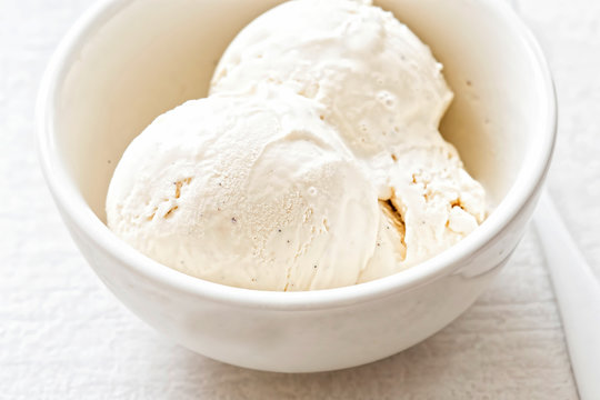 Vanilla ice cream scoops in white bowl 