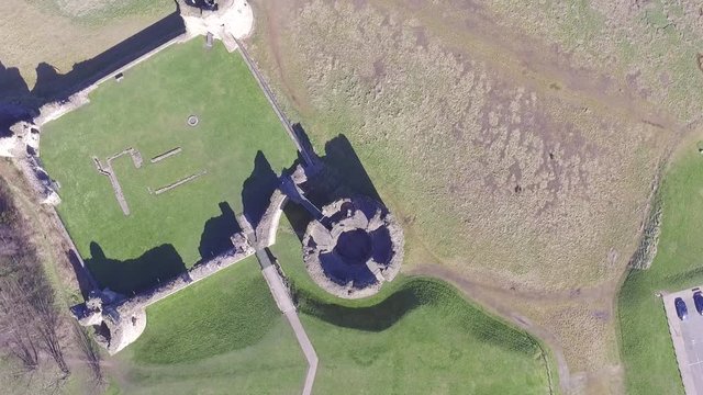 Aerial footage looking down on Flint Castle and moving over Dee Estuary.
