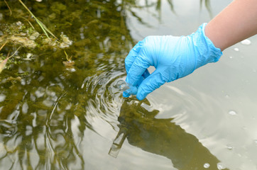 Taking a water test for analysis from a reservoir.
