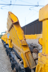Yellow stone transport freight train wagon in railway depot