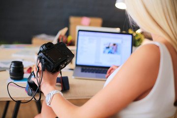 Young photographer and graphic designer at work