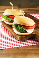 Delicious fresh homemade burger on a wooden table