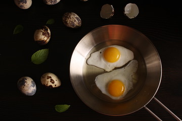 Fried eggs quail egg on a dark background