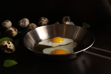 Fried eggs quail egg on a dark background
