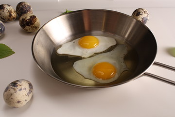 Fried eggs quail egg on a white background