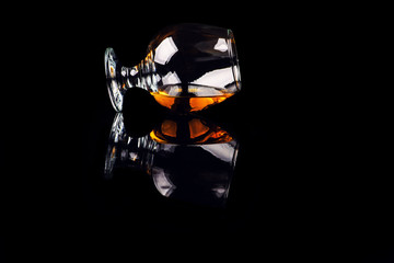 glass with cognac on a black background