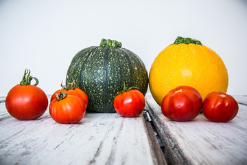 Still-life of pumpkins and tomatoes /  Assorted fresh pumpkins and tomatoes