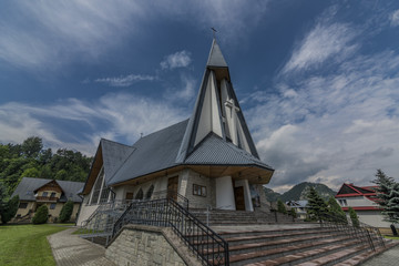 Fototapeta na wymiar Church in Stromowce Nizne village with blue sky