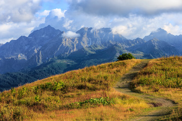 Obraz premium Beautiful scenic summer autumn landscape of Agepsta Peak in Caucasus Mountains in Sochi at sunset. Sunny blue sky scenery with clouds