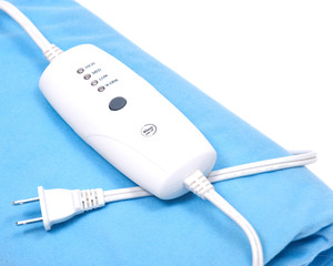 Blue electric heating pad isolated on white background © bjphotographs