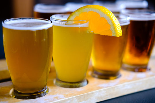 An ice-cold, colorful beer flight with a lemon wedge