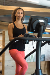 Obraz na płótnie Canvas Young Black Woman on Treadmill