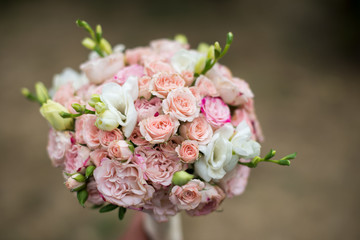pink and white wedding bouquet on a blurred background