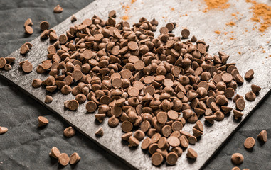 Chocolate chips against black background