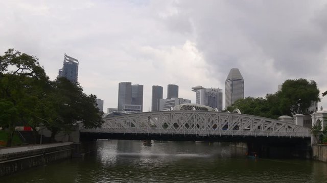 day time rainy sky singapore famous fullerton hotel bridge panorama 4k 
