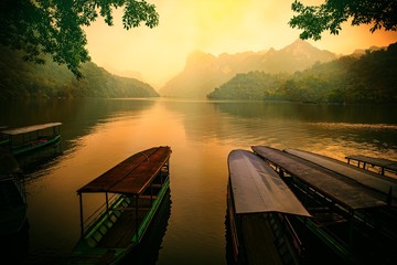 Fototapeta premium Ba Be lake, Bac Kan province, Vietnam - April 4, 2017 : tourists on the boat are going to enjoy and explore Ba Be lake. Stunning scenery of Ba Be Lake in Bac Kan Province, Vietnam