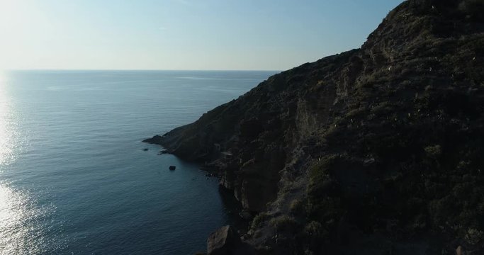 moving forward aerial view of mediterranean sea wild green rocky coast.Nature environment outdoors travel establisher,Italy,Sicily Salina Eolian Island.Sunny summer.4k drone establishing video