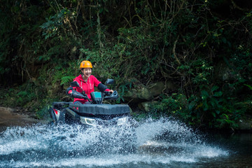 Women are driving an atv adventure in the wild in Asia. © Oulailux