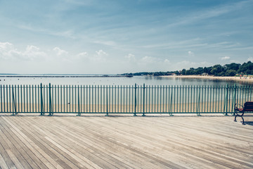Lege oceaan strand promenade pier op warme zomerdag tegen blauwe hemel