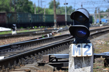 Railway traffic light (semaphore) against the background of a day railway landscape. Signal device...