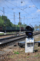 Railway traffic light (semaphore) against the background of a day railway landscape. Signal device...