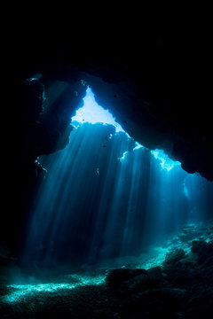 Rays of sunlight into the underwater cave © divedog