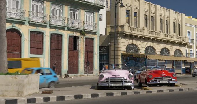 HAVANA, CUBA - Circa July, 2017 - A daytime establishing shot of vintage classic cars on the streets of Havana, Cuba.  	
