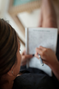 A woman playing a game with pen and paper