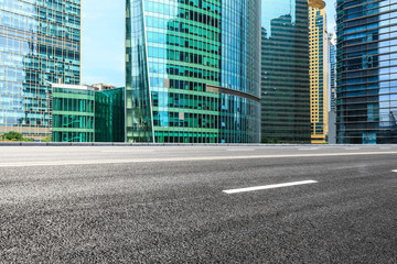 Obraz premium empty asphalt road and modern buildings in shanghai,china.