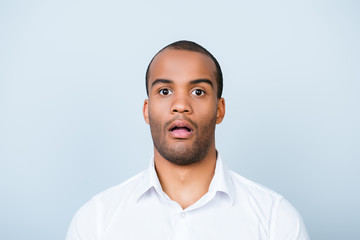 No way! Close up portrait of astonished young freelancer guy, he stands in white smart shirt, on pure light background, shocked