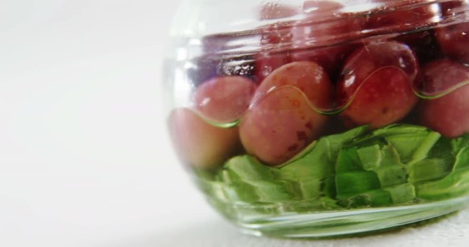 Olives pickled with green vegetables in a jar