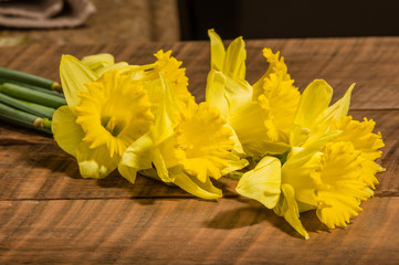 Yellow dafodills on wooden table