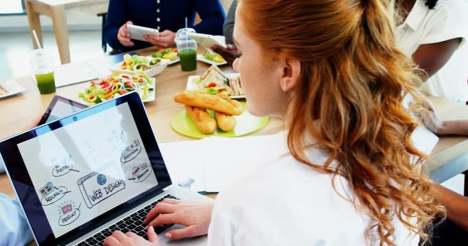 Executives working together in the cafeteria 