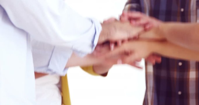 Happy executives forming handstack