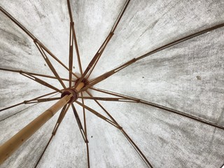 Dirty white umbrella from below