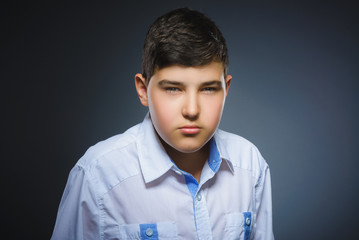angry boy isolated on gray background. Closeup